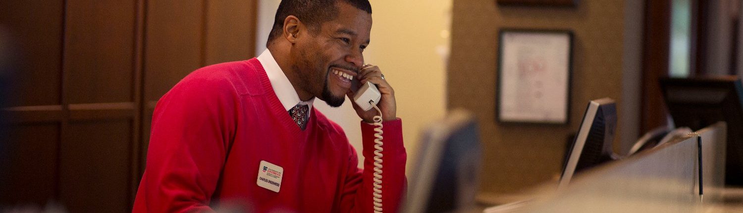 Student working the front desk at the UGA Hotel in Athens, GA