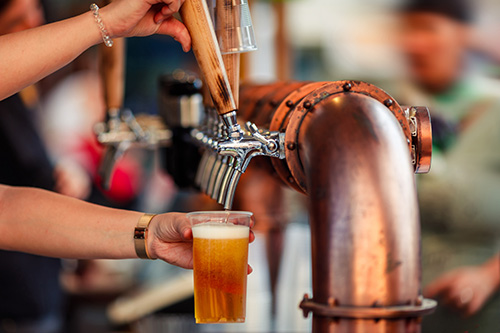 Beer tapping into a plastic cup